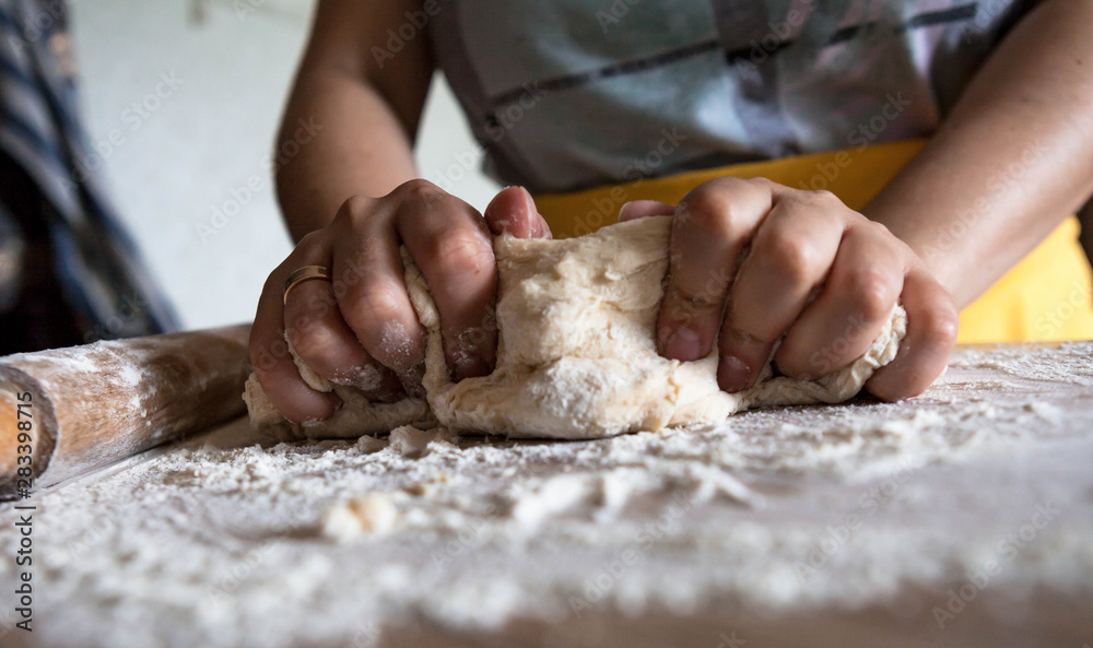 Female hands making dough at home