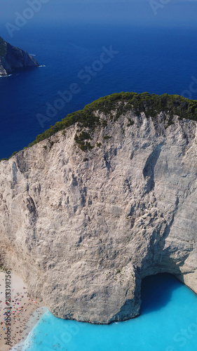 Aerial drone panoramic breathtaking view of iconic beach of Navagio or Shipwreck with deep turquoise clear sea and beautiful clouds, Zakynthos island, Ionian, Greece