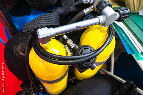 Industrial scuba diving for work under water. Diving equipment. Yellow oxygen tanks for breathing underwater. Diver's outfit. Equipment