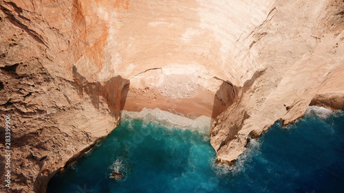 Aerial drone view of iconic beach of Navagio or Shipwreck voted one of the most beautiful beaches in the world with deep turquoise clear sea, Zakynthos island, Ionian, Greece © aerial-drone