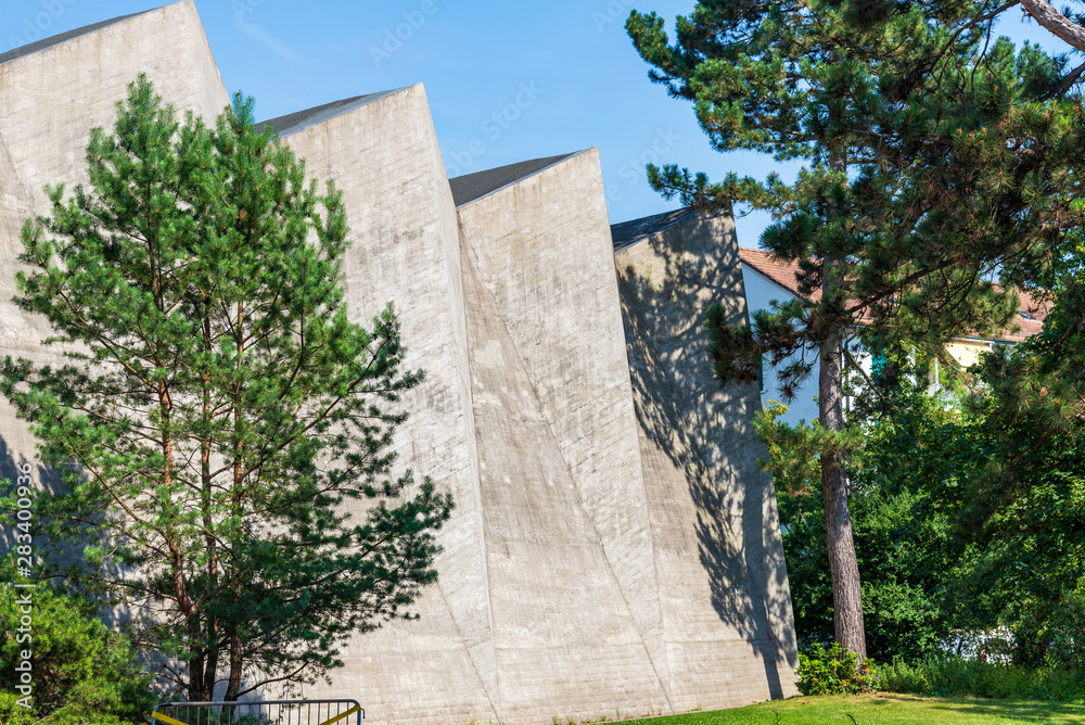 Outdoor sunny view at raw concrete vaulted wall, ceiling and roof of