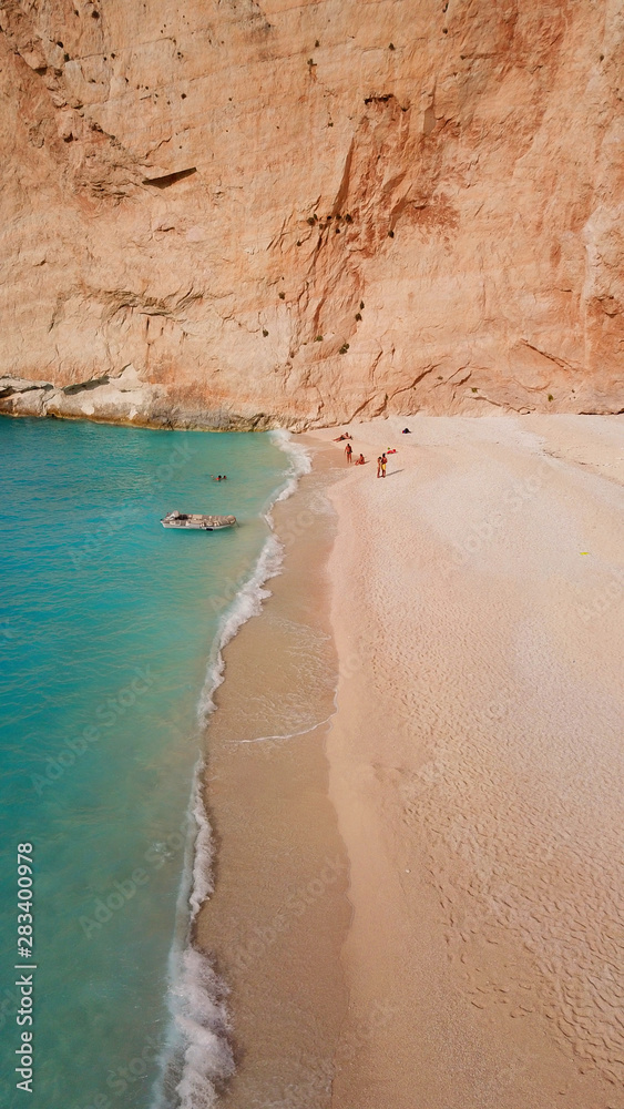 Aerial drone view of iconic beach of Navagio or Shipwreck voted one of the most beautiful beaches in the world with deep turquoise clear sea, Zakynthos island, Ionian, Greece Aerial drone view of iconic beach of Navagio or Shipwreck voted one of the most beautiful beaches in the world with deep turquoise clear sea, Zakynthos island, Ionian, Greece