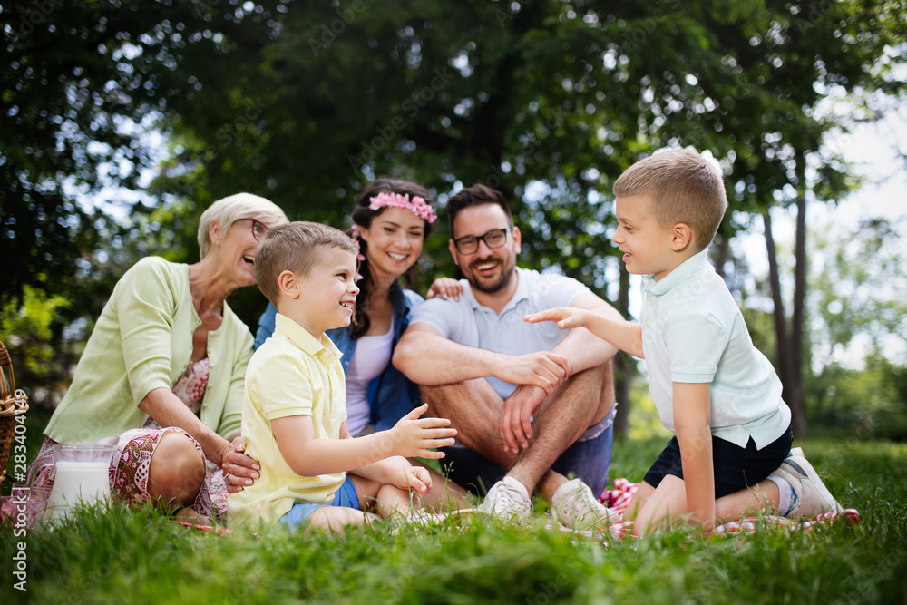 Happy young family enjoying picnic in nature Happy young family enjoying picnic in nature