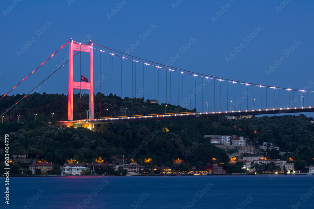 Fototapeta premium Long exposure shot of Fatih Sultan Mehmet Bridge ( FSM ) with light trails after sunset over bosphorus in Istanbul,Turkey. Built in 1988 and connecting Europe and Asia