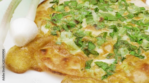 Onion pizza on white dish. National cuisine of Udmurts: The Tabani. Onion Feathers and Tortilla photo