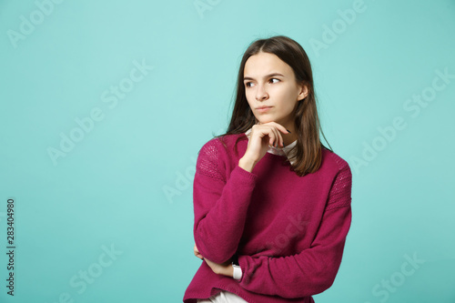Young fun sad upset perplexed disturb brunette woman girl in red casual clothes posing isolated on blue wall background studio portrait. People sincere emotions lifestyle concept. Mock up copy space.