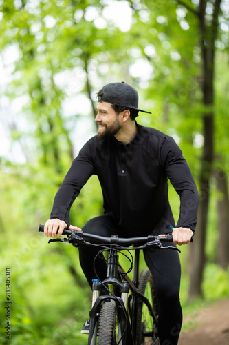 Mountain biker riding on bike in spring inspirational mountains landscape. Sport fitness motivation and inspiration. Rider mountain biking in fall woods. © F8  \ Suport Ukraine