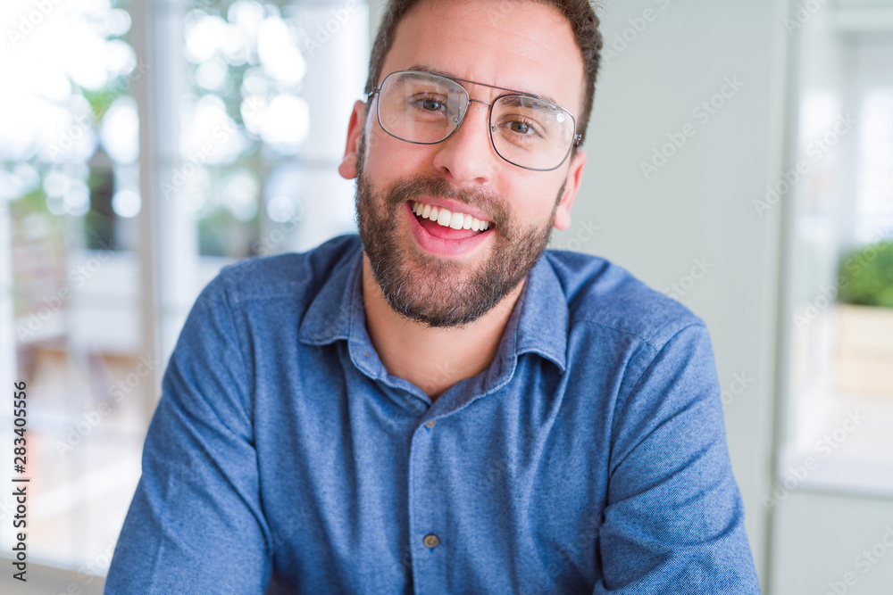 Handsome man wearing glasses and smiling relaxed at camera Handsome man wearing glasses and smiling relaxed at camera