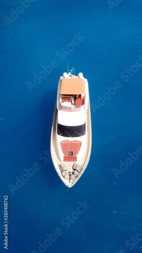 Aerial drone photo of large yacht - boat docked in tropical exotic paradise bay with emerald open ocean © aerial-drone