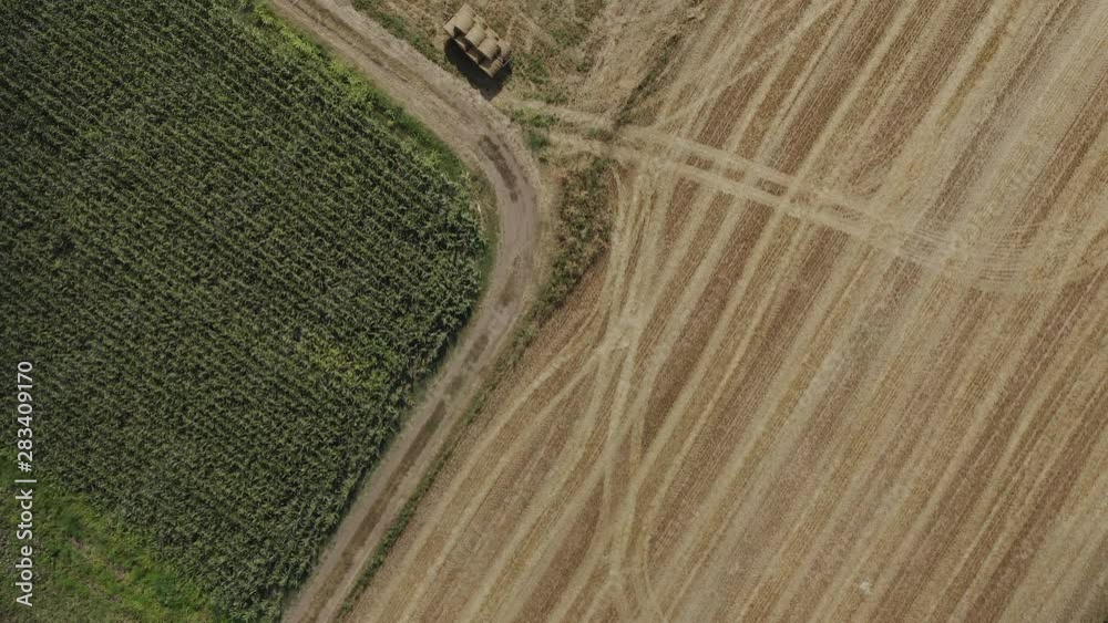 Overhead shot of farmers working on a field with tractors. Top view of an agricultural field with machinery. 4k Overhead shot of farmers working on a field with tractors. Top view of an agricultural field with machinery. 4k