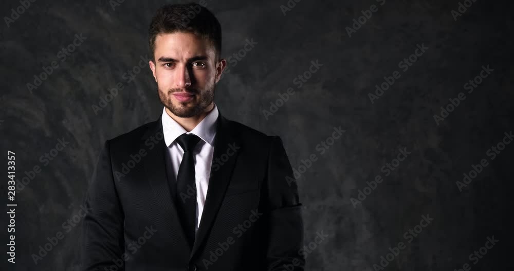 close-up. Portrait of a young businessman in a black suit. the lawyer smiles broadly at the camera, rejoices at the work done. close-up. Portrait of a young businessman in a black suit. the lawyer smiles broadly at the camera, rejoices at the work done.