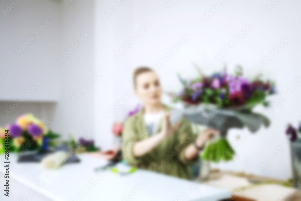 Female florist explain to students how to create bouquet at workplace. Floristics workshop. Making beautiful flower bouquets and floral decorations... Female florist explain to students how to create bouquet at workplace. Floristics workshop. Making beautiful flower bouquets and floral decorations...