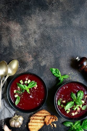 Cold summer beetroot soup with fresh cucumber ( gazpacho ) . Top view with copy space.