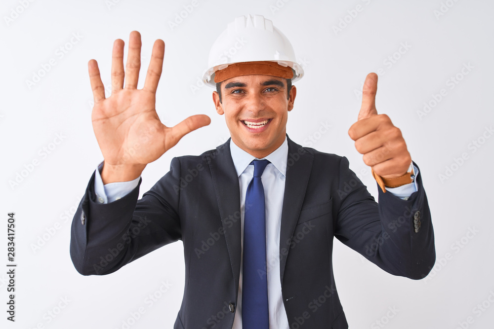 Young handsome architect man wearing suit and helmet over isolated white background showing and pointing up with fingers number six while smiling confident and happy. Young handsome architect man wearing suit and helmet over isolated white background showing and pointing up with fingers number six while smiling confident and happy.