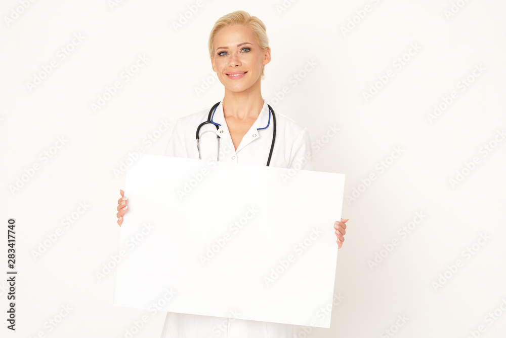 Good looking doctor is holding a white banner. Good looking doctor is holding a white banner.