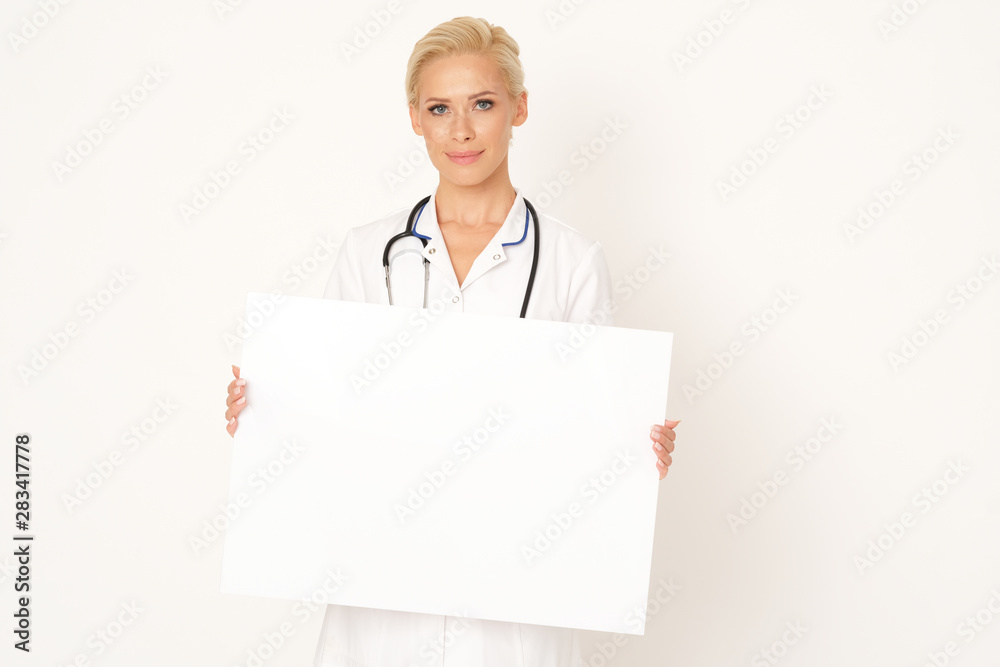Good looking doctor is holding a white banner. Good looking doctor is holding a white banner.