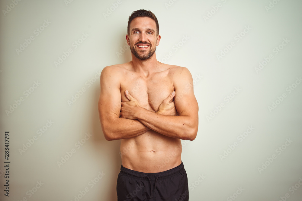 Young handsome shirtless man over isolated background happy face smiling with crossed arms looking at the camera. Positive person.