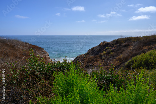 Newport Beach view of the ocean from a mountain trail in South California in a summer beautiful blue day