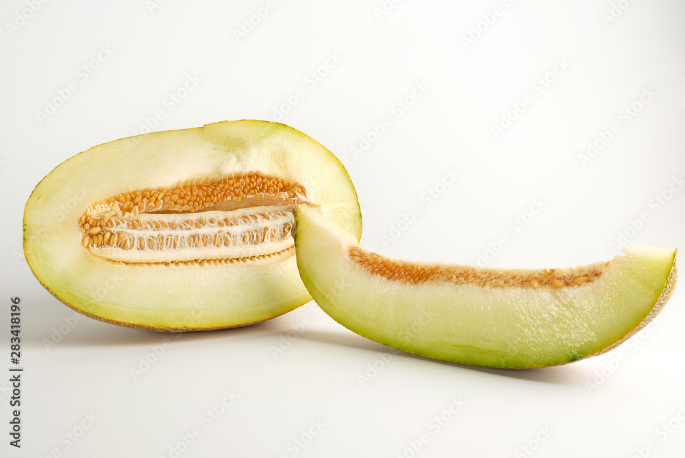 piece of ripe melon with seeds on a white background piece of ripe melon with seeds on a white background
