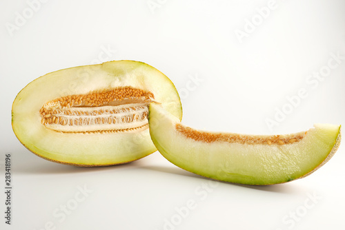 piece of ripe melon with seeds on a white background