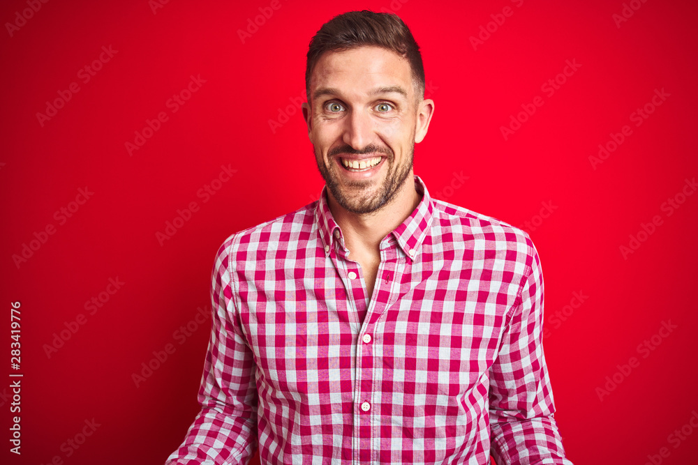 Young handsome man over red isolated background smiling cheerful with open arms as friendly welcome, positive and confident greetings Young handsome man over red isolated background smiling cheerful with open arms as friendly welcome, positive and confident greetings