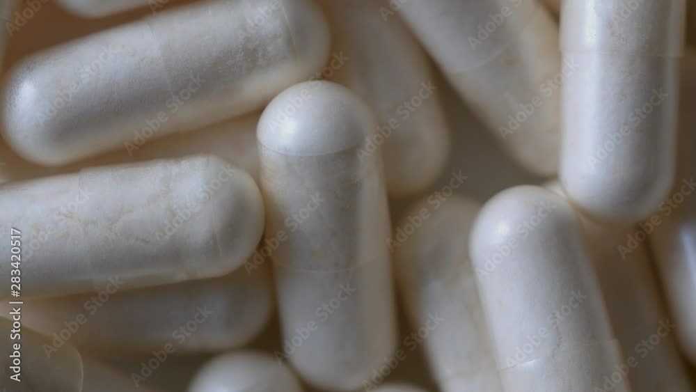 Macro Close-up of A Rotating Heap of Capsules, Pharmacy Background With Selected Focus Macro Close-up of A Rotating Heap of Capsules, Pharmacy Background With Selected Focus