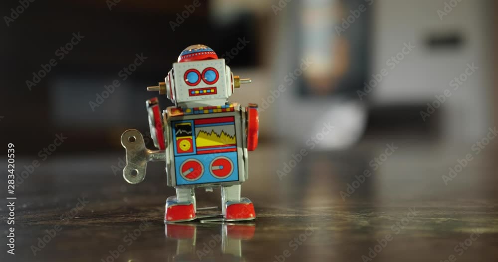 A close up view of a retro children's wind up robot toy. Looping.  	