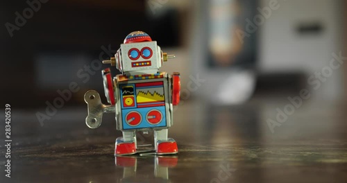 A close up view of a retro children's wind up robot toy. Looping.  	