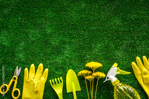 Gardening tools on green grass background top view mockup