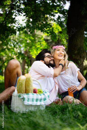 Happy young couple enjoying a picnic in the park together