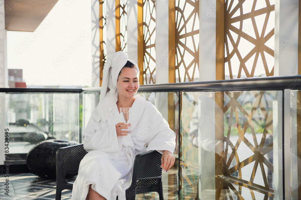 View of young woman resting on balcony at luxury resort, spa in a hotel. View of young woman resting on balcony at luxury resort, spa in a hotel.