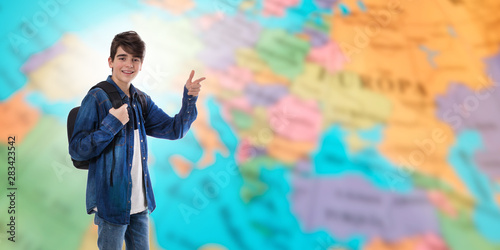 student with backpack and books on map background