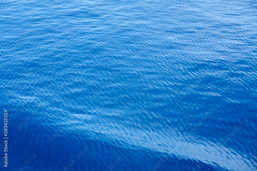 Obraz premium Blue waving sea water as a natural background texture.