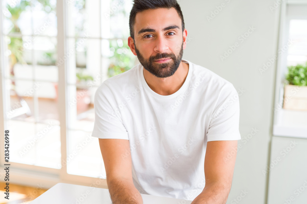 Handsome man looking relaxed and confident Handsome man looking relaxed and confident