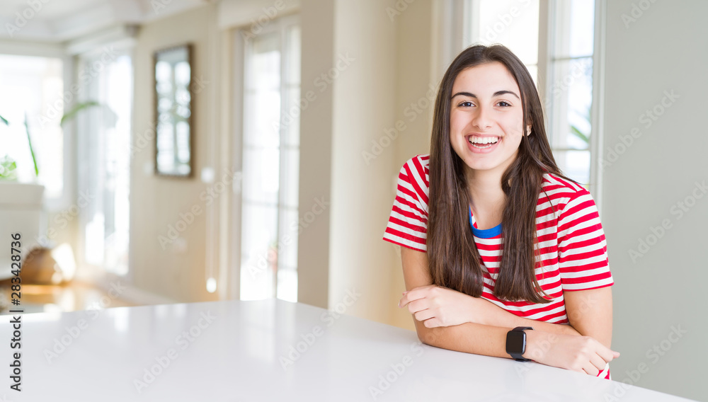 Beautiful young woman wearing casual stripes t-shirt with a happy and cool smile on face. Lucky person.