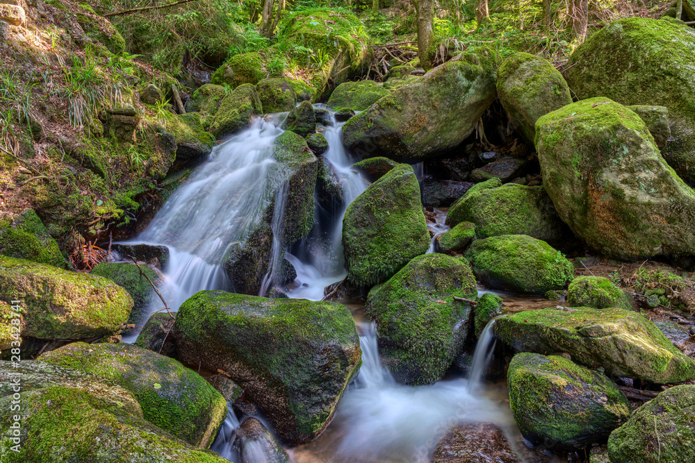 Water streaming over rocky cascades along famous Gertelbach waterfalls, Black Forest, Germany Water streaming over rocky cascades along famous Gertelbach waterfalls, Black Forest, Germany