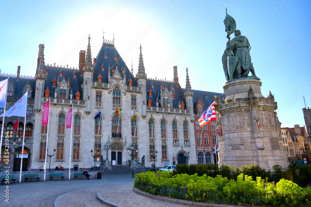 Fototapeta premium Bruges, Belgium - April 26, 2019 - The Provinciaal Hof (Province Court) is a Neogothical building on the market place in Bruges, Belgium.