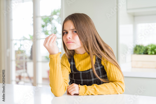 Young beautiful blonde kid girl wearing casual yellow sweater at home Doing Italian gesture with hand and fingers confident expression Free Download Young beautiful blonde kid girl wearing casual yellow sweater at home Doing Italian gesture with hand and fingers confident expression - GFXLoad