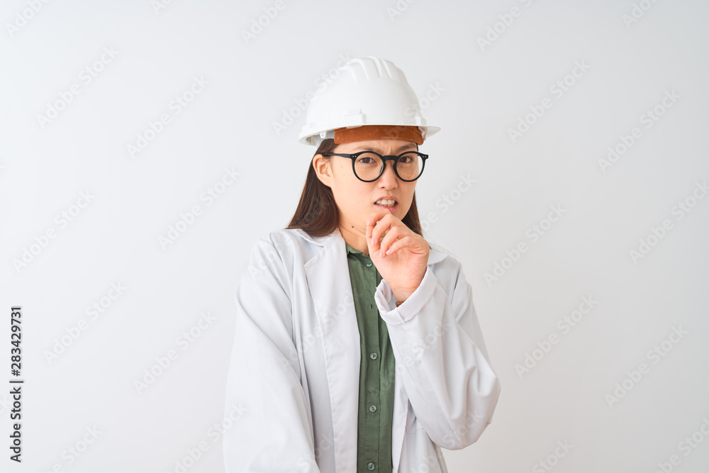 Young chinese engineer woman wearing coat helmet glasses over isolated white background disgusted expression, displeased and fearful doing disgust face because aversion reaction. With hands raised. Young chinese engineer woman wearing coat helmet glasses over isolated white background disgusted expression, displeased and fearful doing disgust face because aversion reaction. With hands raised.