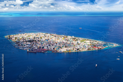 aerial view on male the capital city of maldives. overcrowded island in the indian ocean  blue ocean sea background photo