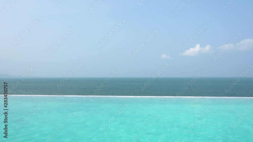 Beautiful blue infinity pool overlooking ocean Beautiful blue infinity pool overlooking ocean
