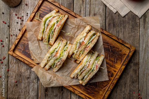 club sandwich with chicken on wooden board