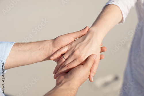 Close-up man and woman hand touching holding together on blurred background for love and healing concept