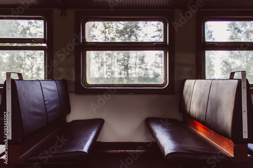 Empty seats inside passenger car of old electrical train