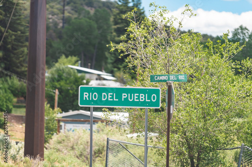 Rio del Pueblo village sign in High Road to Taos historic town street in mountains