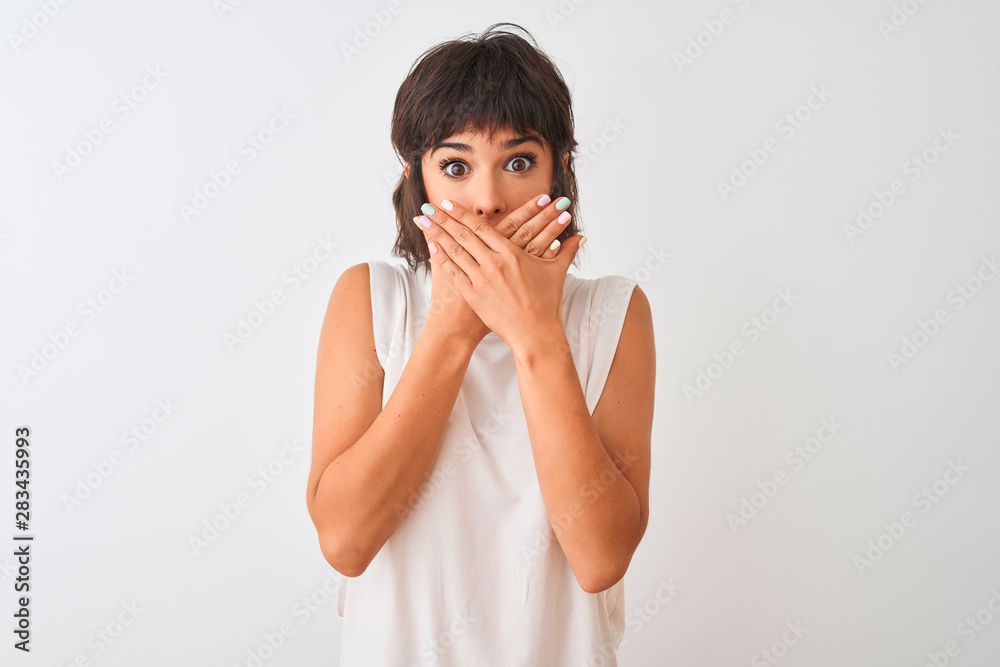 Young beautiful woman wearing casual t-shirt standing over isolated white background shocked covering mouth with hands for mistake. Secret concept. Young beautiful woman wearing casual t-shirt standing over isolated white background shocked covering mouth with hands for mistake. Secret concept.