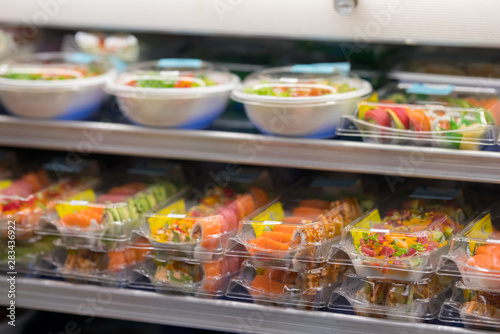 Fresh sushi for sale at a supermarket deli in togo containers