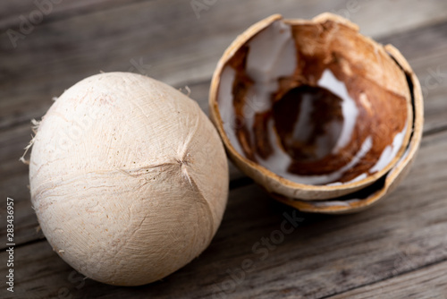 Peeled coconut on wood table background
