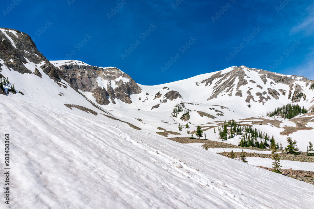 Summit and white hill in Thomas Lakes Hike in Mt Sopris, Carbondale, Colorado in early 2019 summer with snow on peak