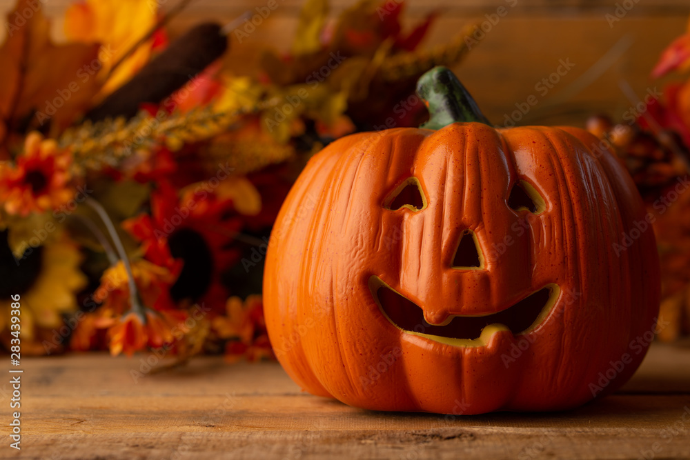 Fototapeta premium Halloween pumpkin head jack lantern on a wooden background, background for the holiday
